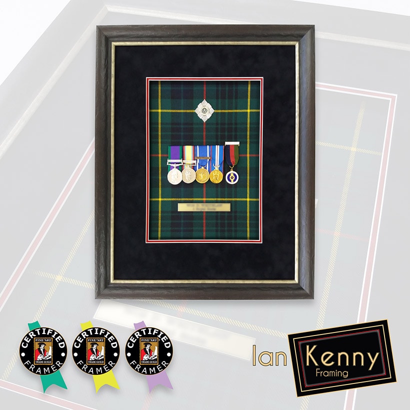 Framed Service medals backed onto a tartan backing