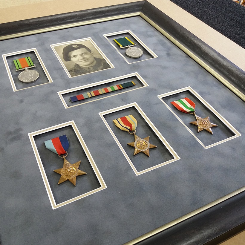 War medals and photograph in a multi-aperture composition