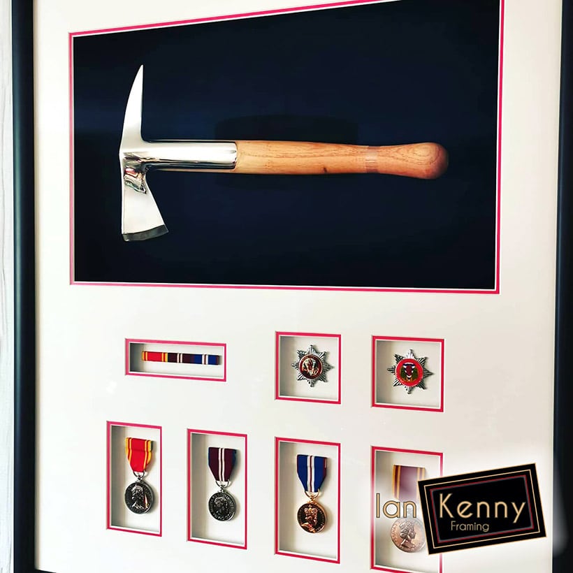 A framed Fireman's axe and medals in multi-apertures